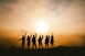 silhouette photo of six persons on top of mountain