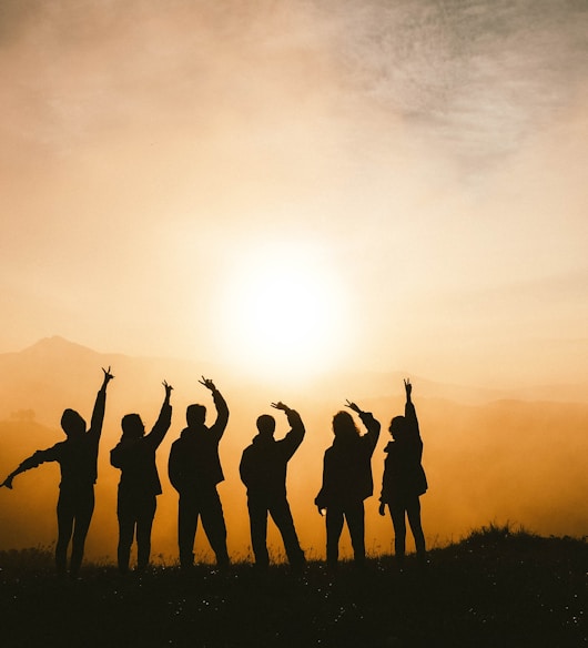 silhouette photo of six persons on top of mountain