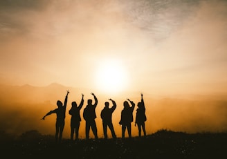 silhouette photo of six persons on top of mountain