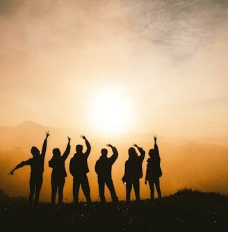 silhouette photo of six persons on top of mountain