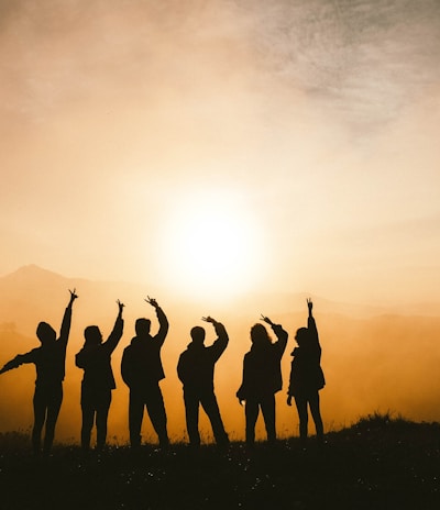 silhouette photo of six persons on top of mountain