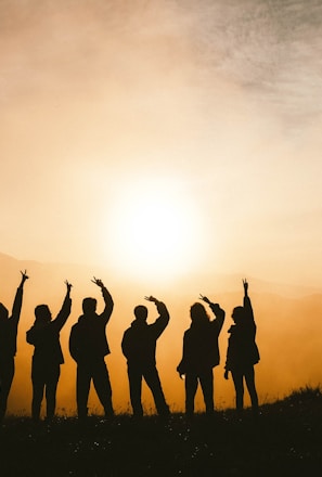 silhouette photo of six persons on top of mountain