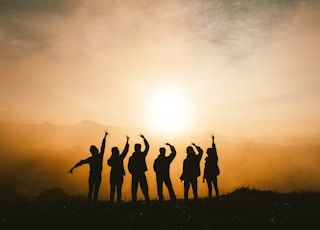 silhouette photo of six persons on top of mountain