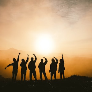 silhouette photo of six persons on top of mountain