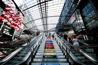 A vibrant elevator screen displaying a colorful advertisement in a busy office building lobby