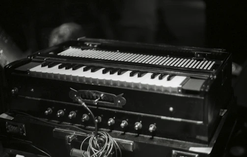A close-up of a tabla and harmonium set up ready for a performance.
