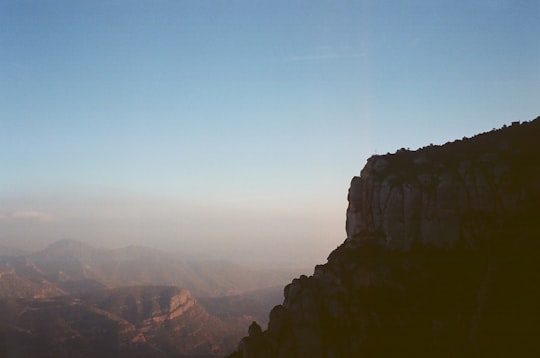 gray mountain under blue sky during daytime in Montserrat (mountain) Spain