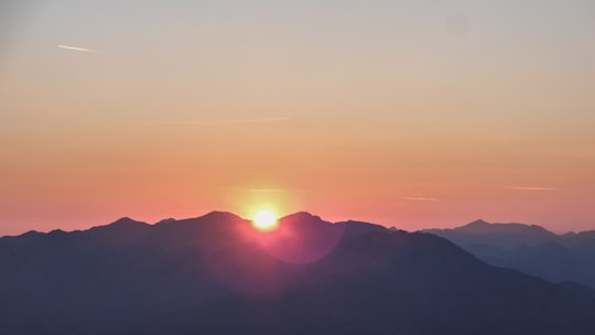 silhouette photo of mountain during dawn in Serles Austria