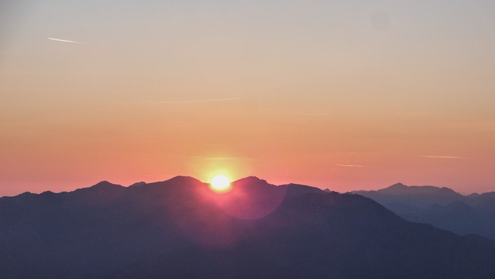 silhouette photo of mountain during dawn