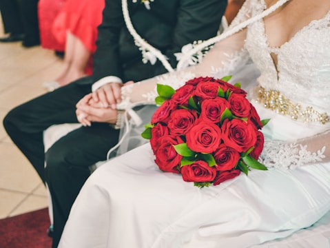 A bride and groom holding hands with illustrated story background.