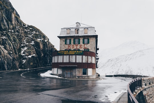 gray and red Hotel house in the middle of road in Hotel Belvedere Switzerland