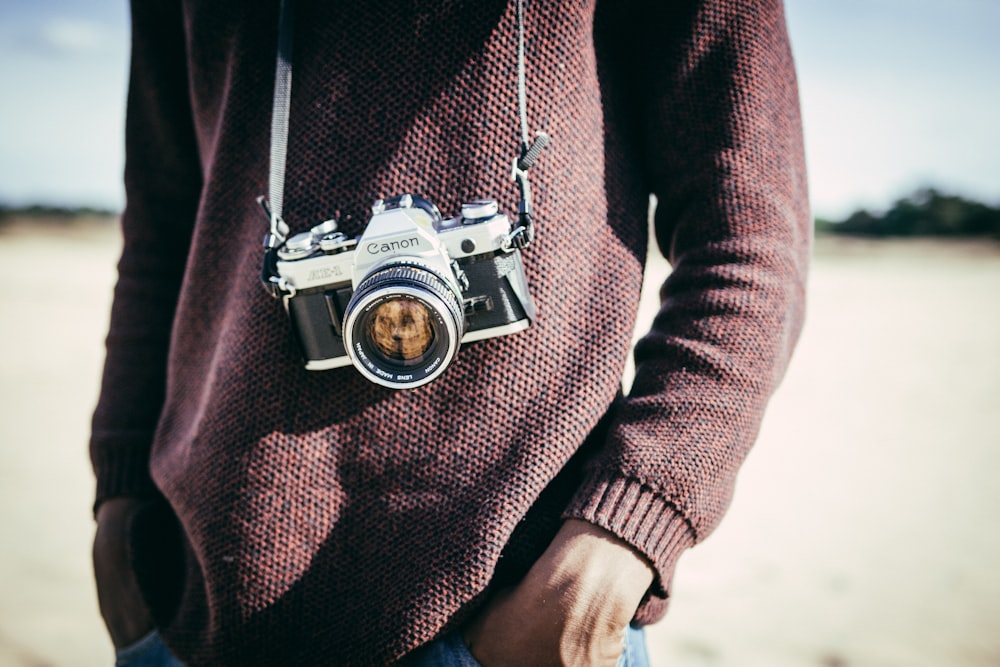 person in brown sweatshirt with mirror less camera