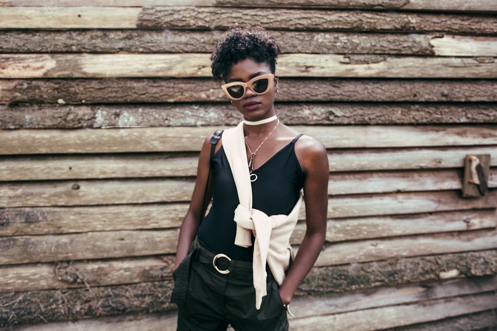 woman in black spaghetti strap top posing for photograph