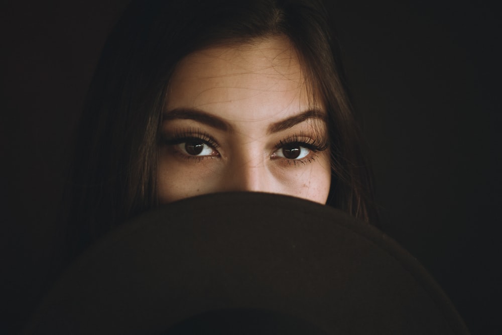 woman covering her mouth and nose