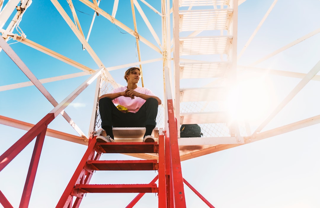 man sitting on red staircase