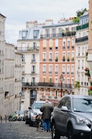 man walking beside gray vehicle\