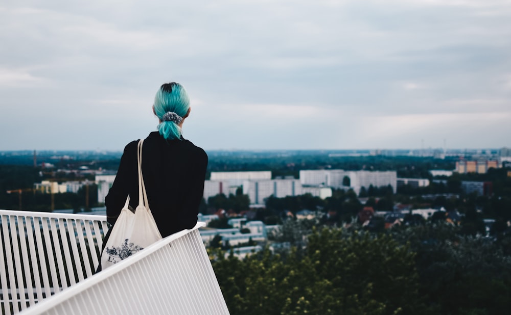 woman standing beside handrails