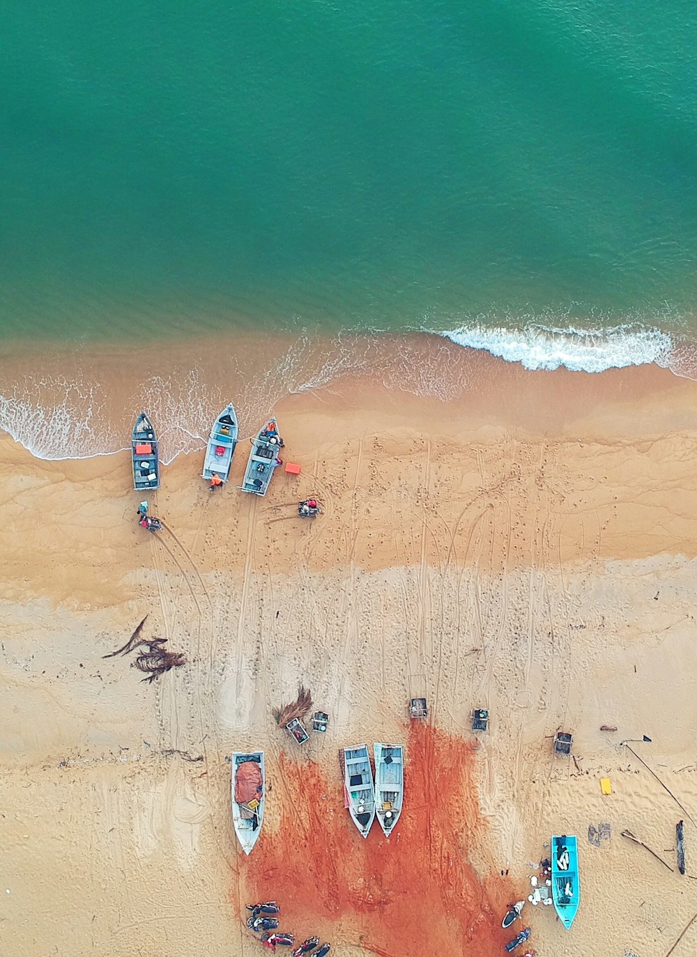 Fotografía aérea de un barco junto a la orilla del mar durante el día