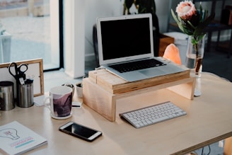 silver MacBook on desk