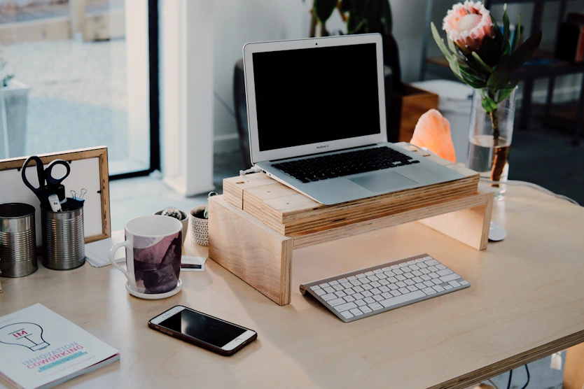 silver MacBook on desk