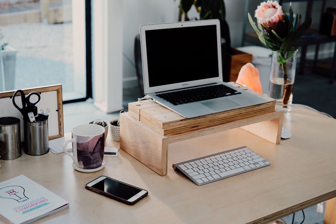 silver MacBook on desk