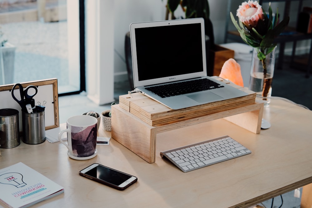 silver MacBook on desk