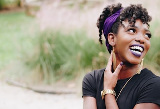 photo of woman wearing purple lipstick and black crew-neck shirt