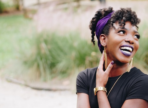 photo of woman wearing purple lipstick and black crew-neck shirt