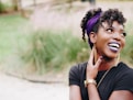 photo of woman wearing purple lipstick and black crew-neck shirt