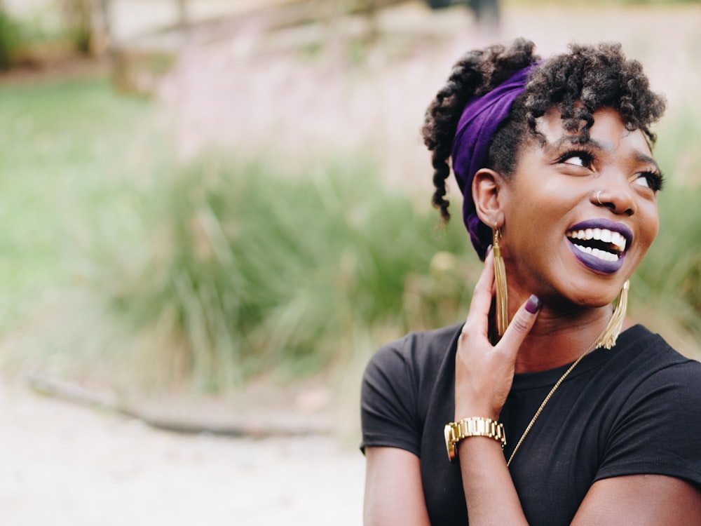 photo of woman wearing purple lipstick and black crew-neck shirt