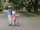 two toddler's walking on road near green tree