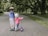 two toddler's walking on road near green tree