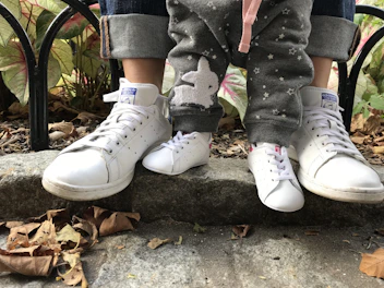 A family scene showing children and women wearing matching stylish shoes in natural light.