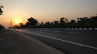 An open road leading towards a sunrise, representing new beginnings.