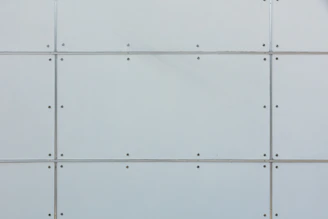 Close-up of a worker inspecting a heavy-duty prestressed wall panel at the factory.