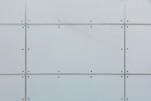 Close-up image of a thermal insulated sandwich panel showing its layers and texture.