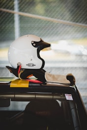 white half-face helmet on vehicle rooftop