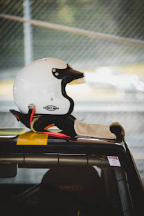 white half-face helmet on vehicle rooftop
