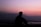 silhoutte of man sitting on ground