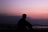 silhoutte of man sitting on ground