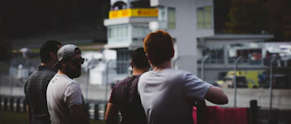 A group of business professionals enjoying a VIP hospitality area at a motorsport event.