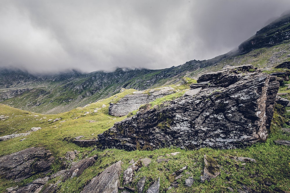 green and brown mountain under cloudy sky