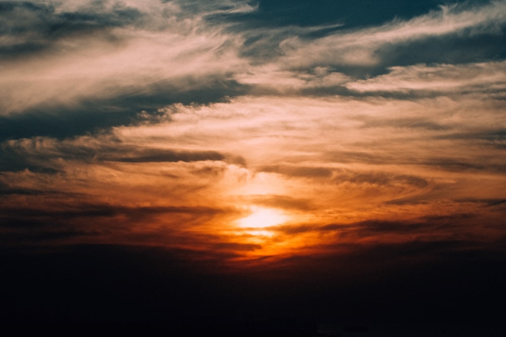 photography of sun covered by clouds during dawn