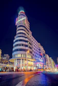 gray Schweppes building turn-on lights during night time