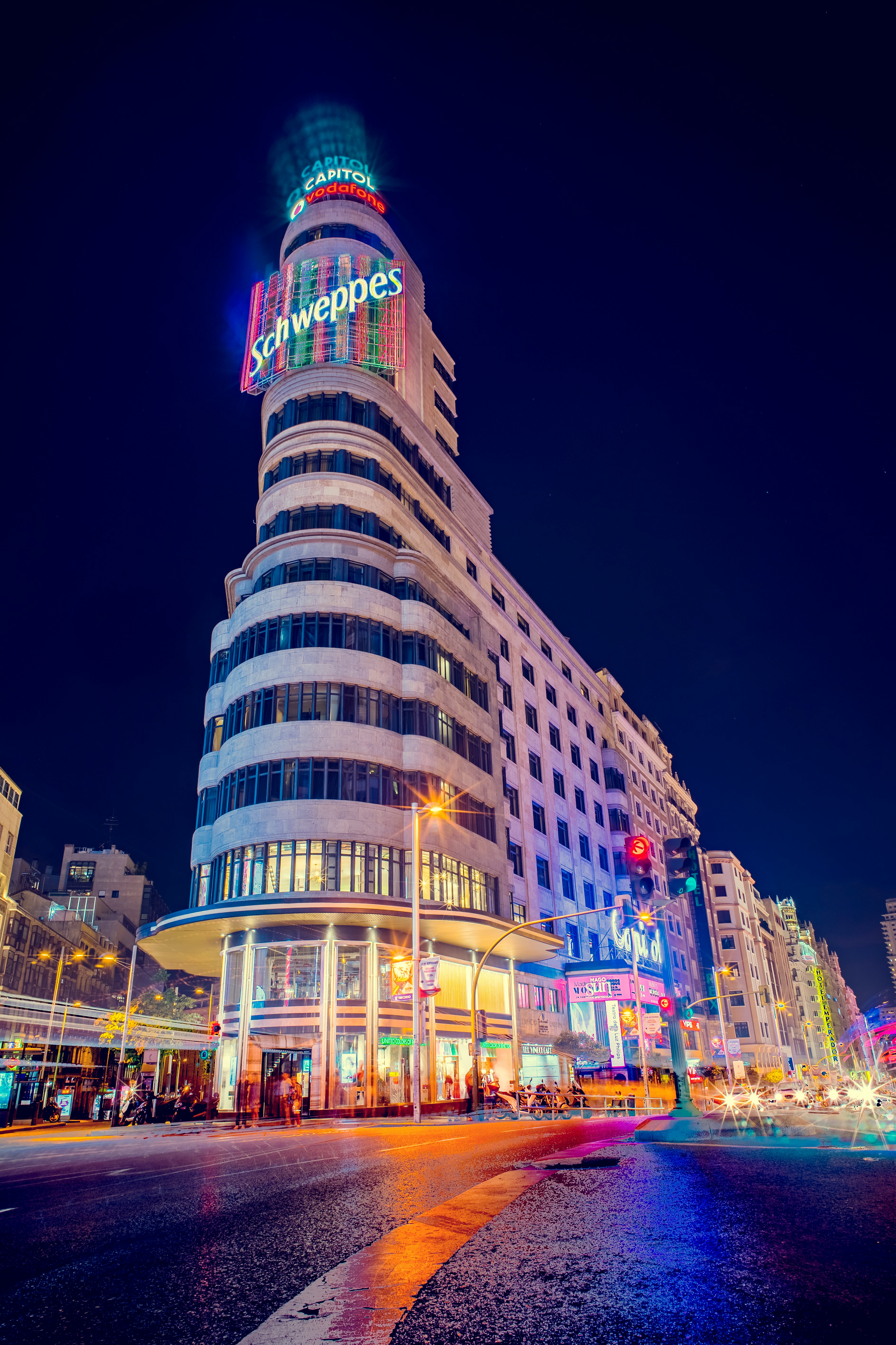 gray Schweppes building turn-on lights during night time