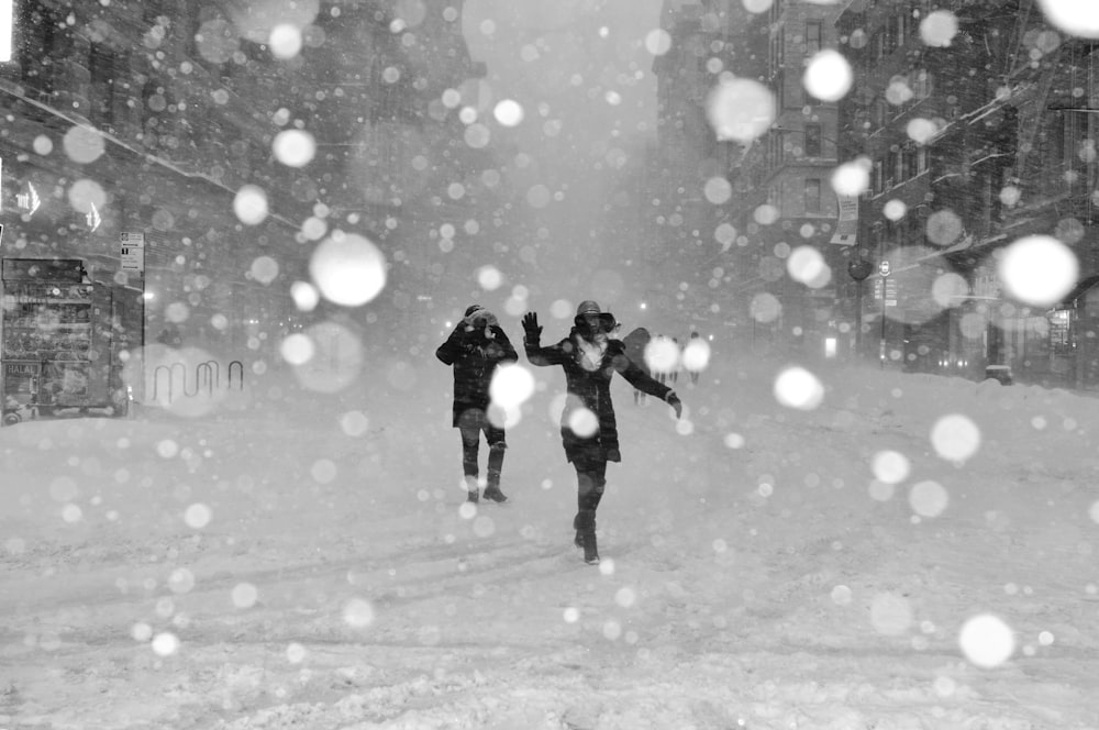 people walking on snow covered street with bokeh effects photo