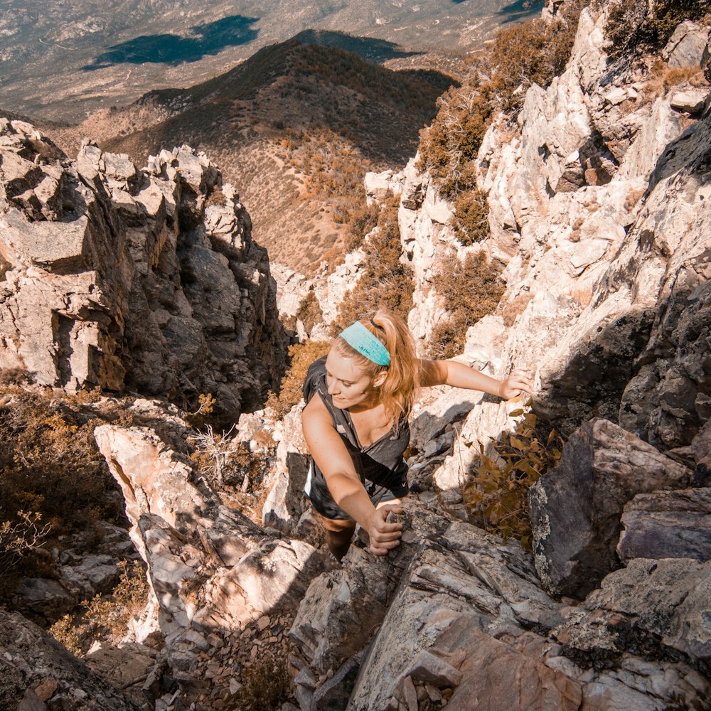 photo of woman climbing mountain