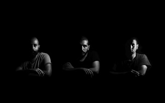 greyscale photo of three men