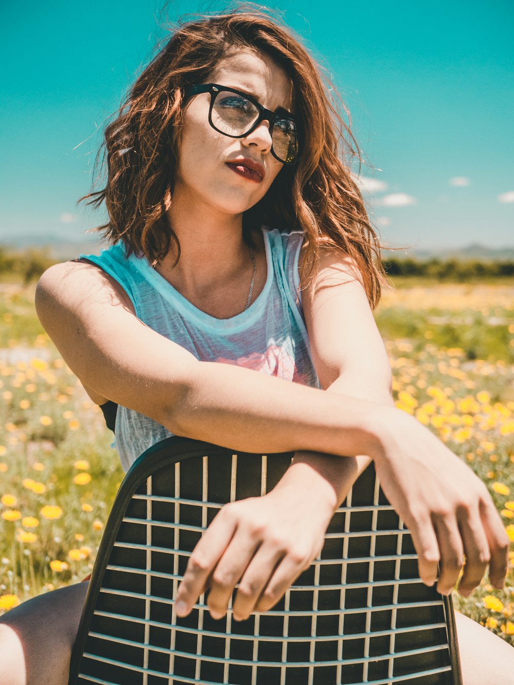 woman wearing black eyeglasses sitting on the black padded chair