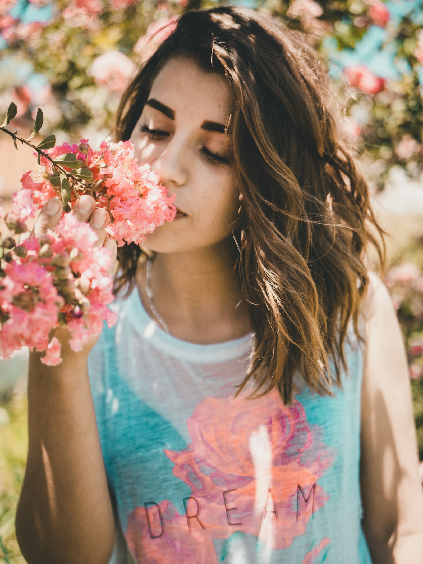 Panasonic Lumix DMC-G7 + LUMIX G 25/F1.7 sample photo. Woman smelling pink flowers photography